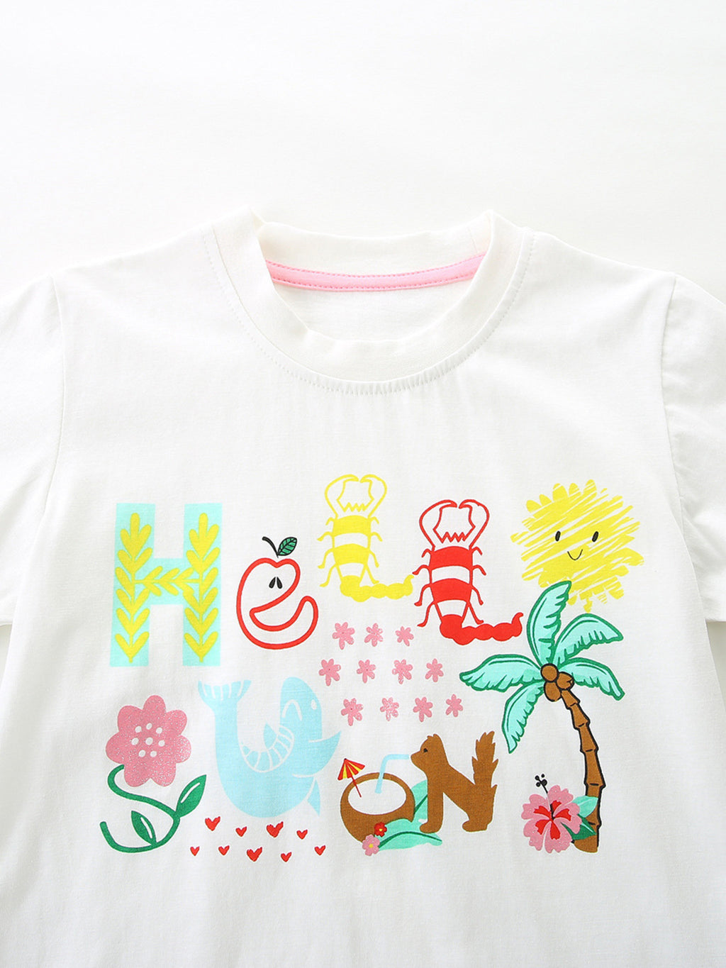White short-sleeve T-shirt with colorful cartoon graphic and ruffled hem