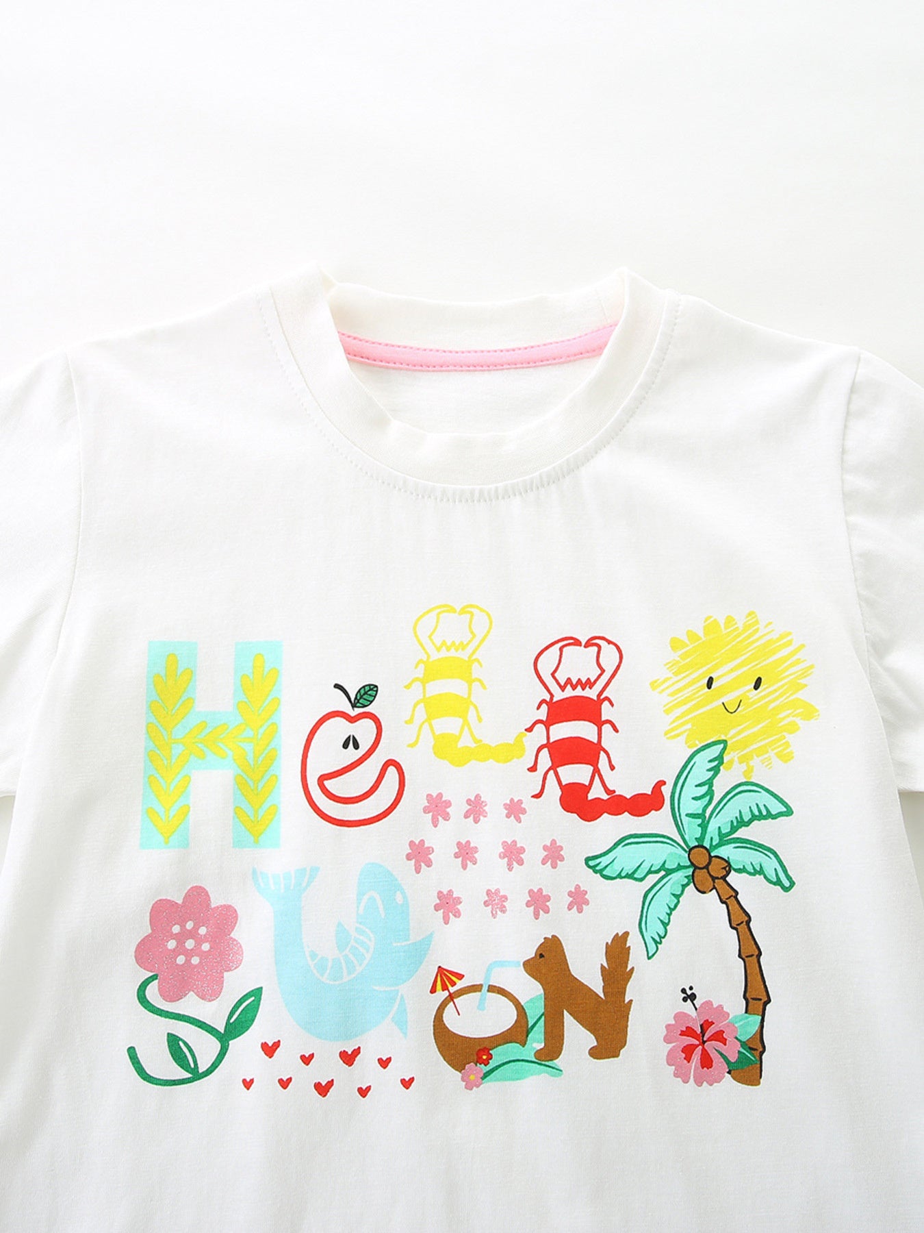 White short-sleeve T-shirt with colorful cartoon graphic and ruffled hem
