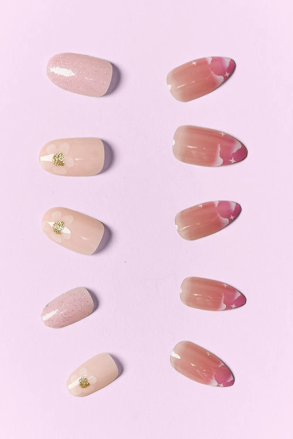 Naturistic press-on nails: nude tones with glitter, marbling, and small gold embellishments