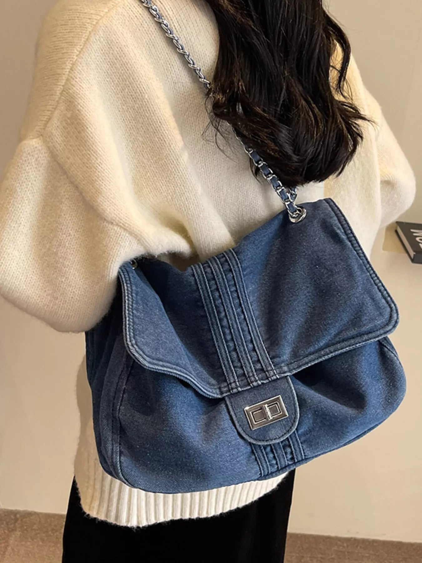 Blue denim flap chain shoulder bag with stitched panels and front logo clasp