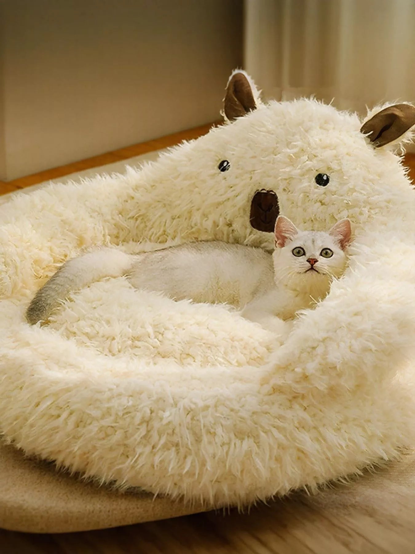 Bear-shaped cozy plush pet nest in cream fur, cat peeking inside