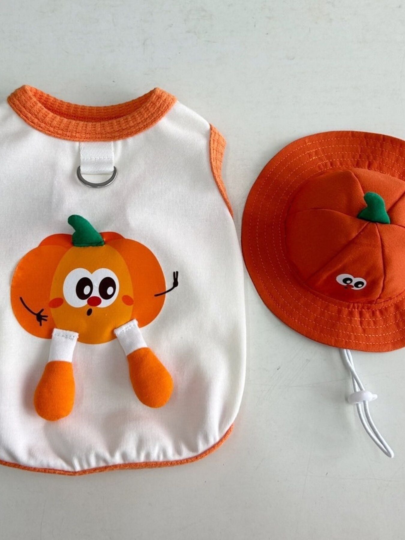 White pet tank with orange pumpkin character appliqué and orange neckline trim