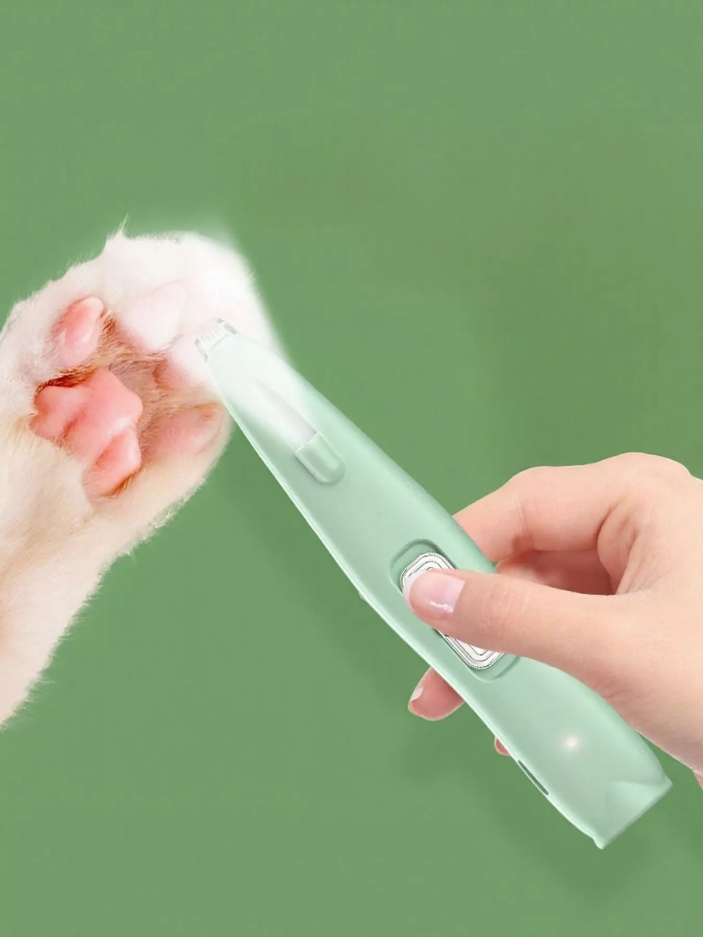 Green rechargeable pet hair clipper held in hand, blade visible