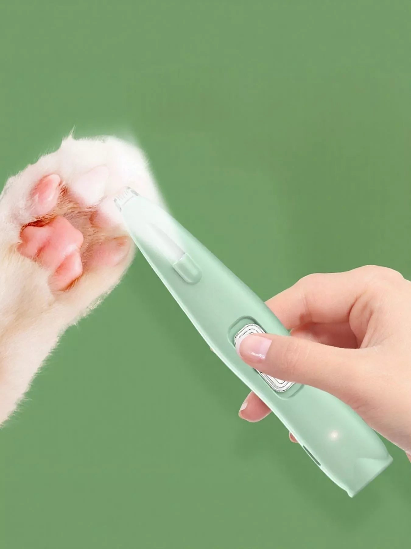 Green rechargeable pet hair clipper held in hand, blade visible