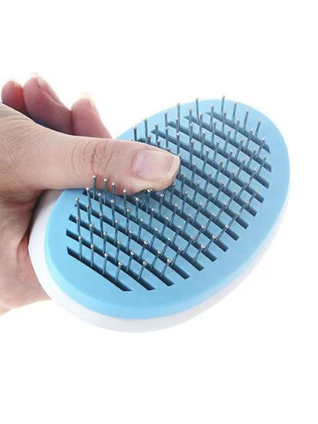 Sky blue pet hair remover comb held in hand, oval head with dense metal pin teeth
