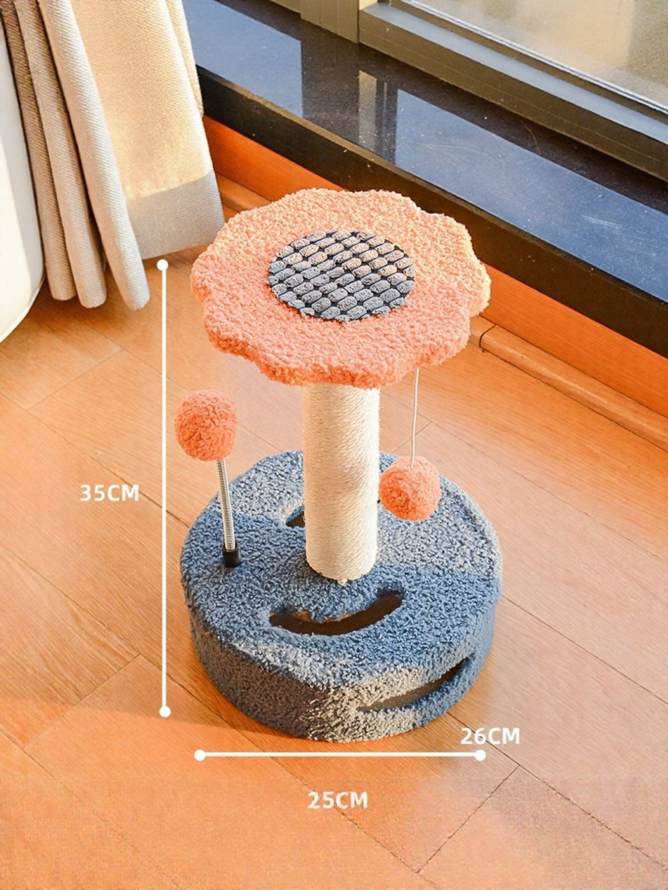 Cat scratching post with dangling balls in orange top and dark blue base, with circular pads