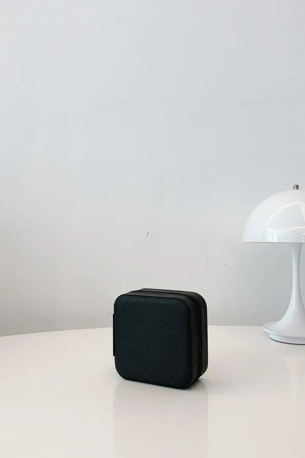 Black PU leather square jewelry box, standing upright with stitched edges.