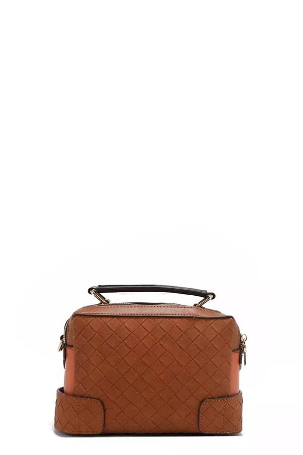 Brown quilted mini satchel front view with top handle and side snap pockets