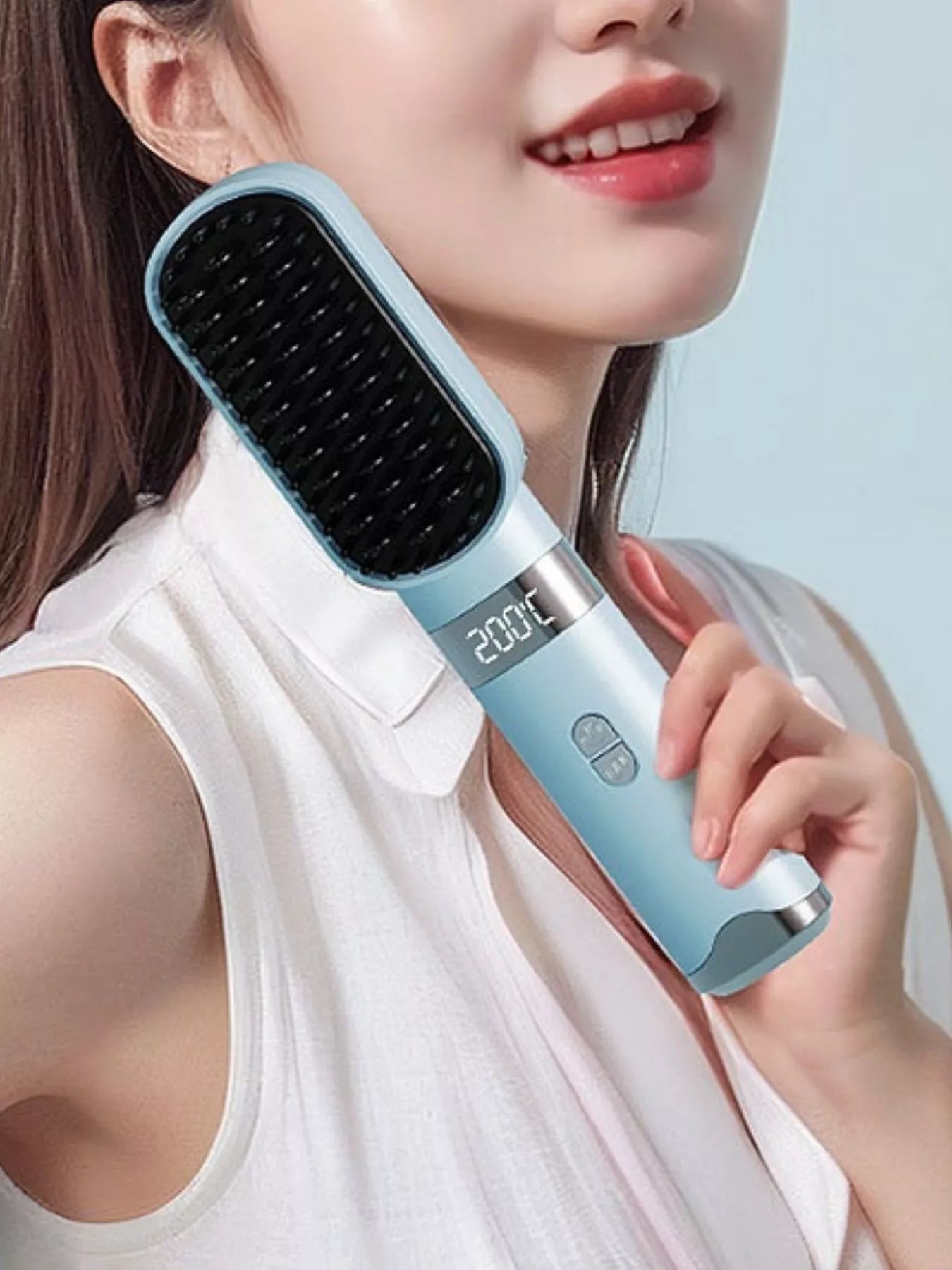 Light blue heated straightening comb with black bristles; LCD reads 200°C