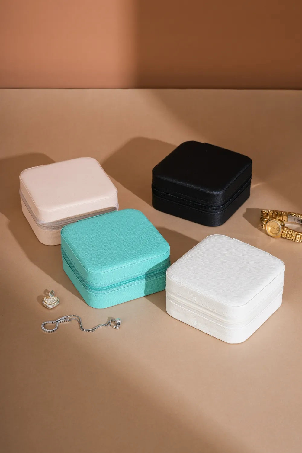 Square PU jewelry boxes in white, black, and turquoise with zip-top design