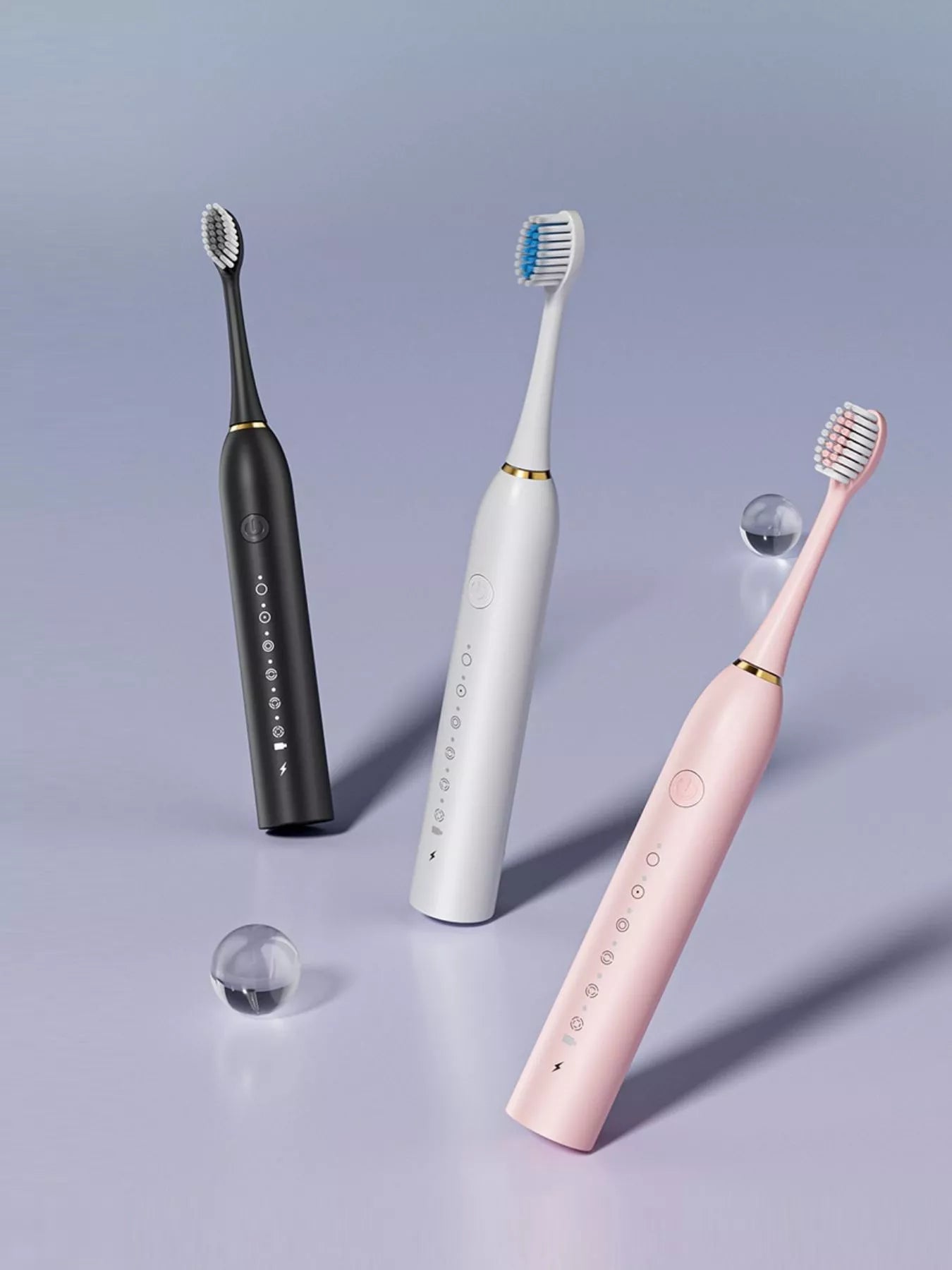 Electric toothbrushes in black, white, and pink with multi-mode button layout