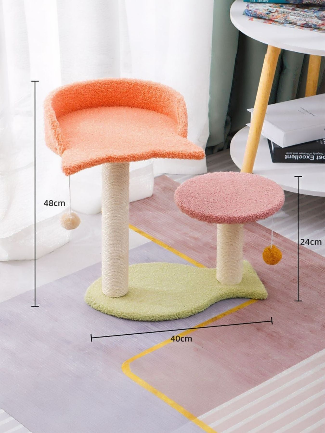 Orange and green cat scratching post with two platforms on rope poles and pom toy