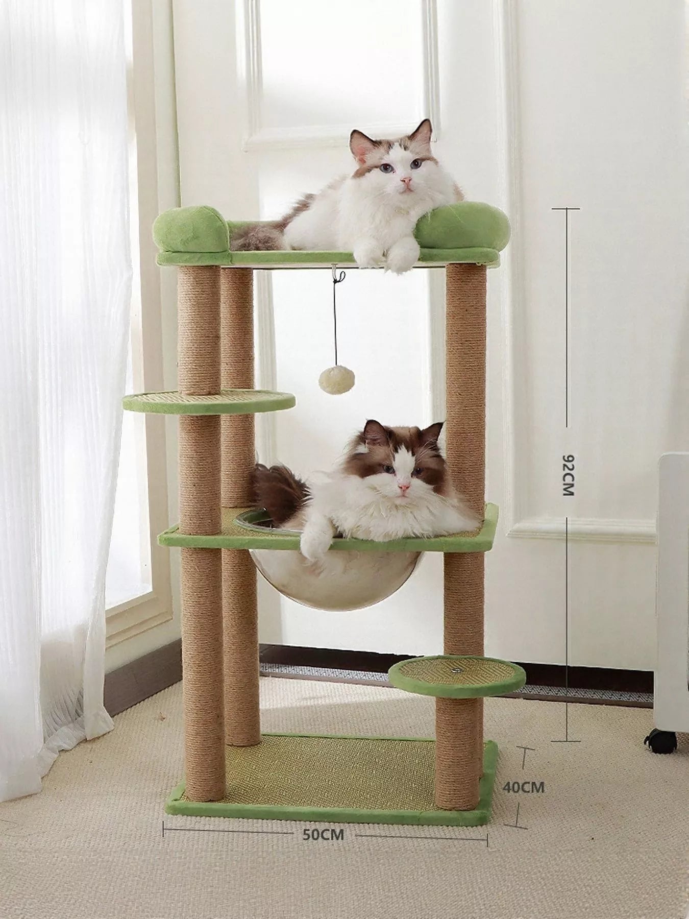 Plush cat tree condo in green accents with sisal scratching posts and rounded hammock bed