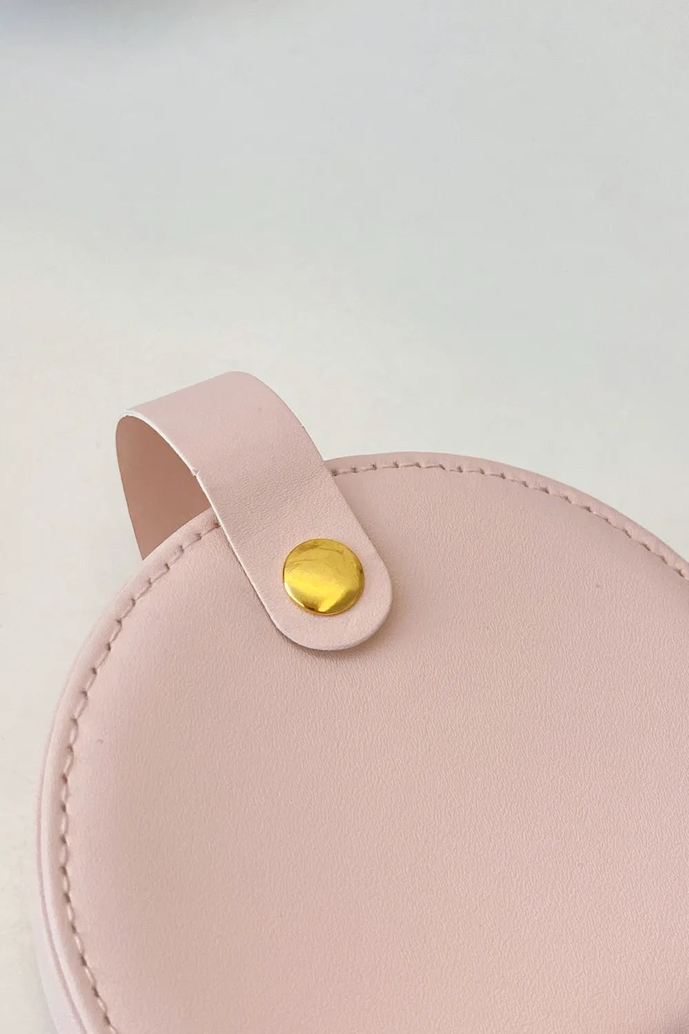 Blush pink PU leather travel jewelry box lid with round gold snap button