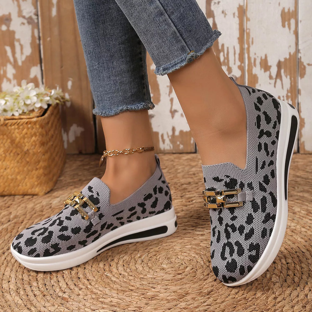 Gray leopard mesh slip-ons with gold double-buckle strap and white sole