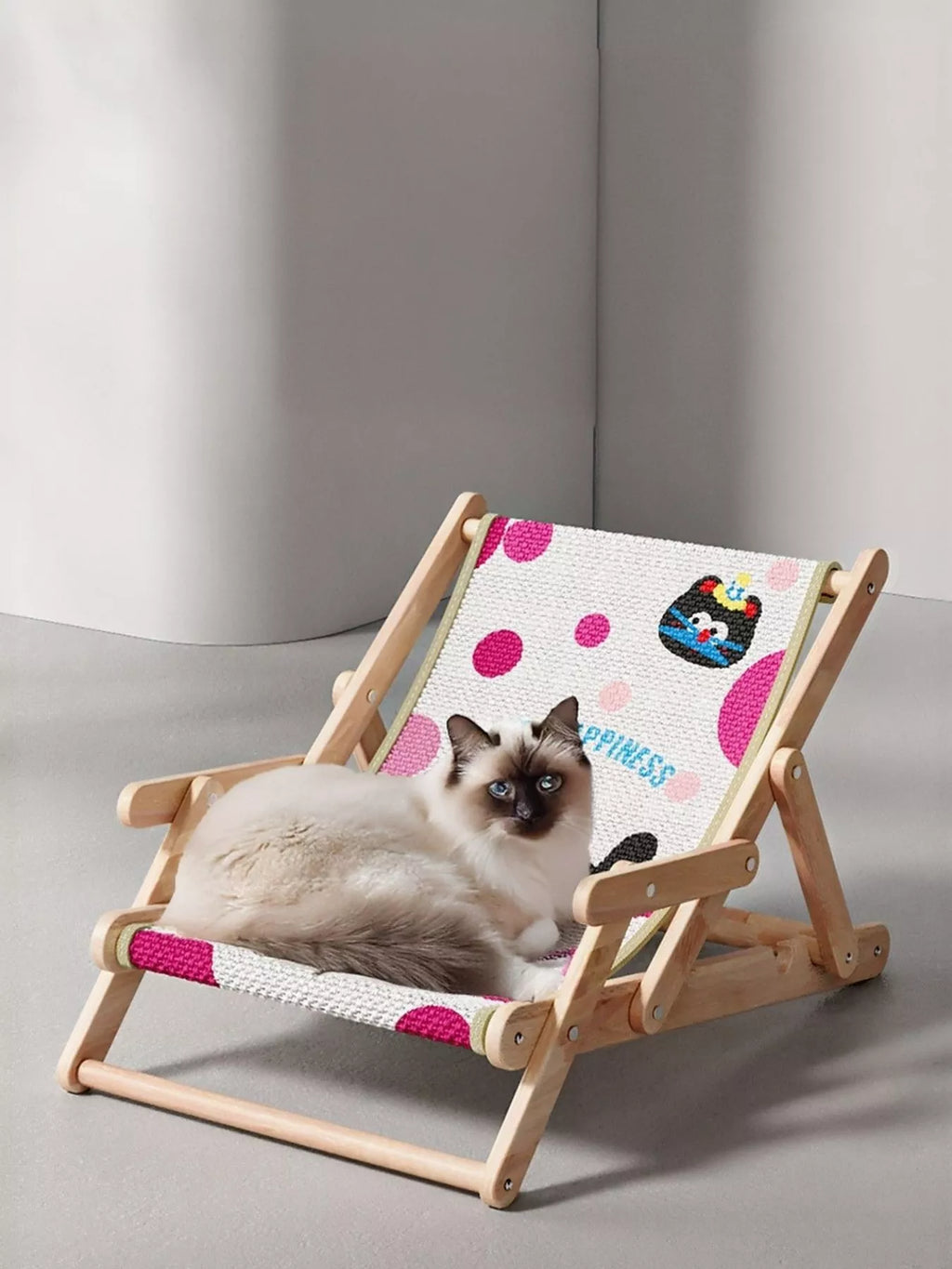 Wooden pet chair with polka dot black cat pattern, cat resting on cushioned seat