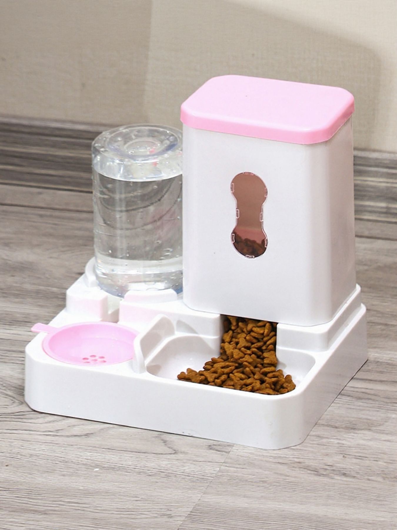Automatic pet food and water dispenser with pink lid, food tray and water tank.