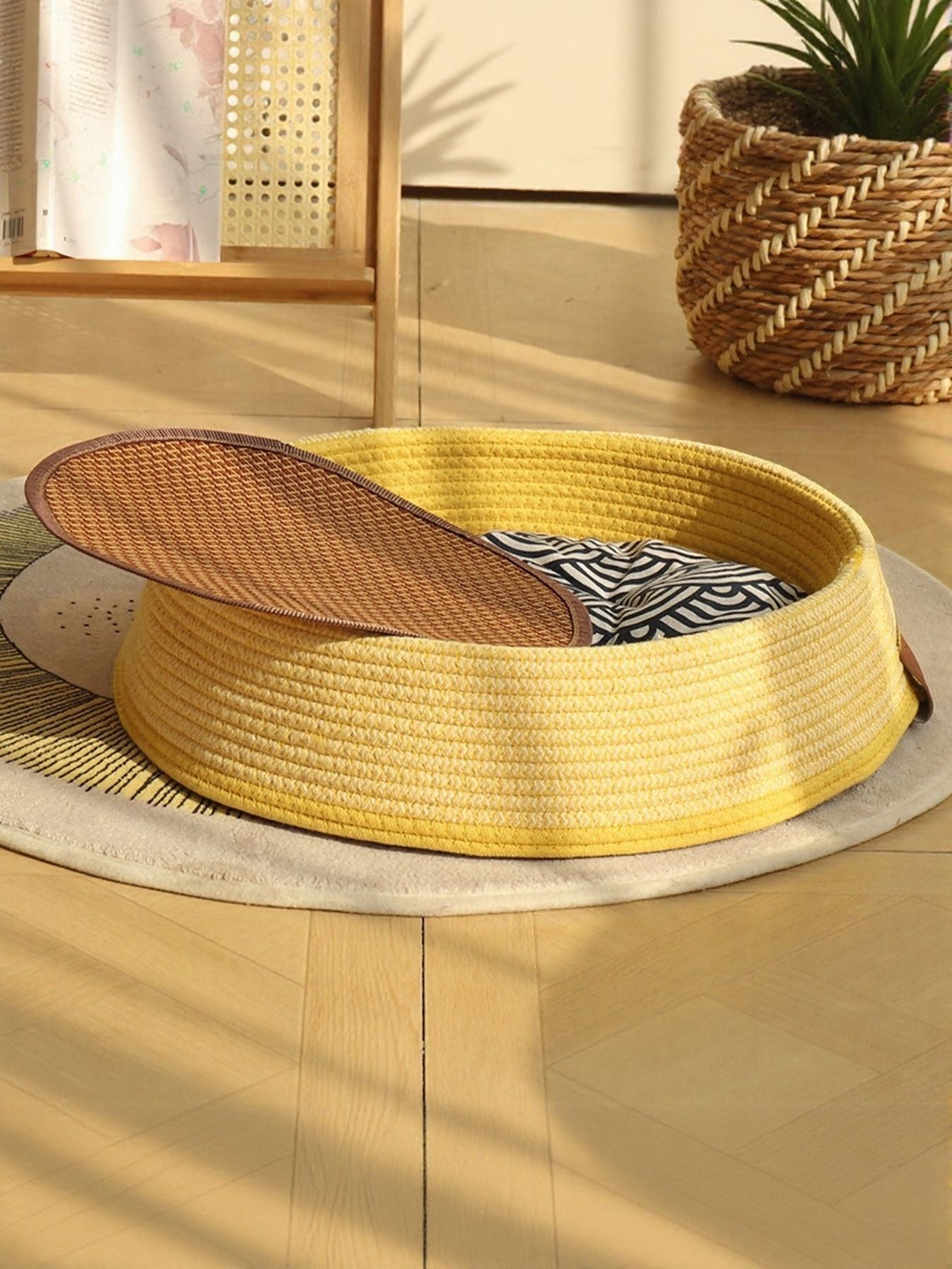 Woven rattan pet nest with yellow woven rim and zebra-pattern inner cushion, brown lid