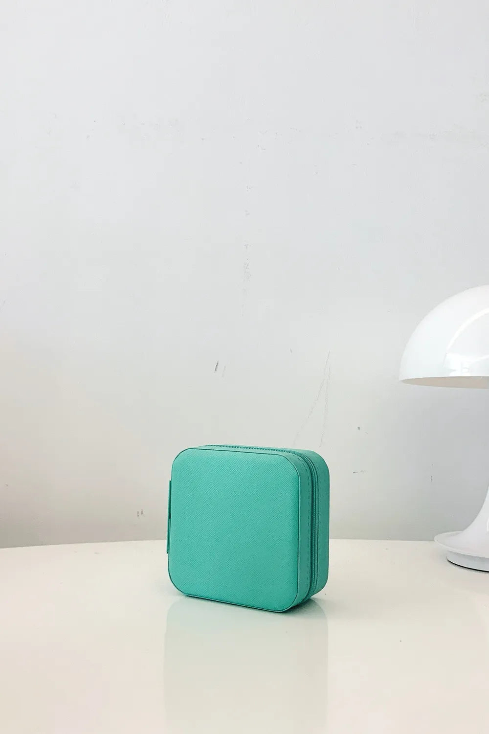 Turquoise PU leather square jewelry box with textured finish and zip closure