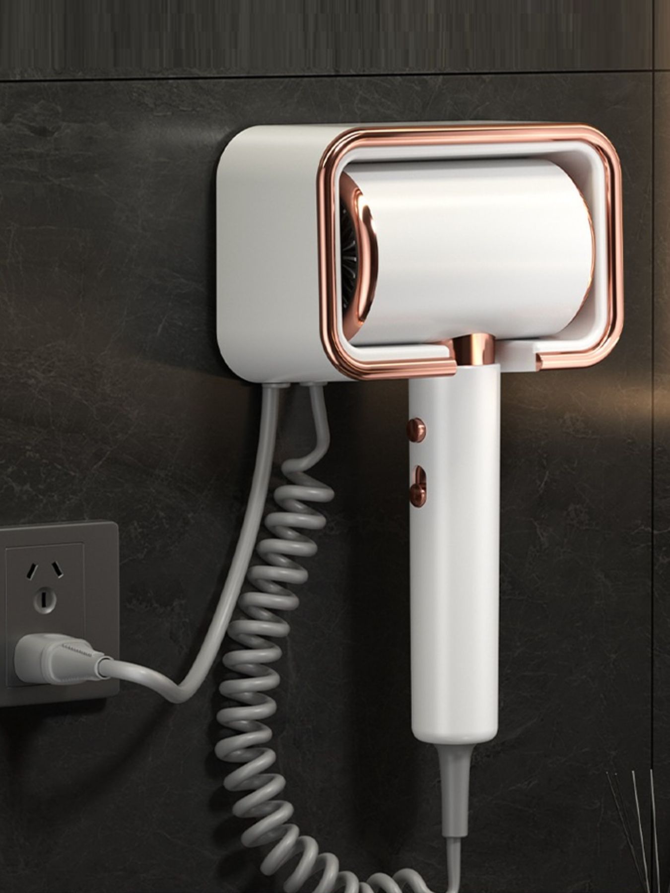 White hair dryer with rose-gold frame, textured grip area and hanging cord