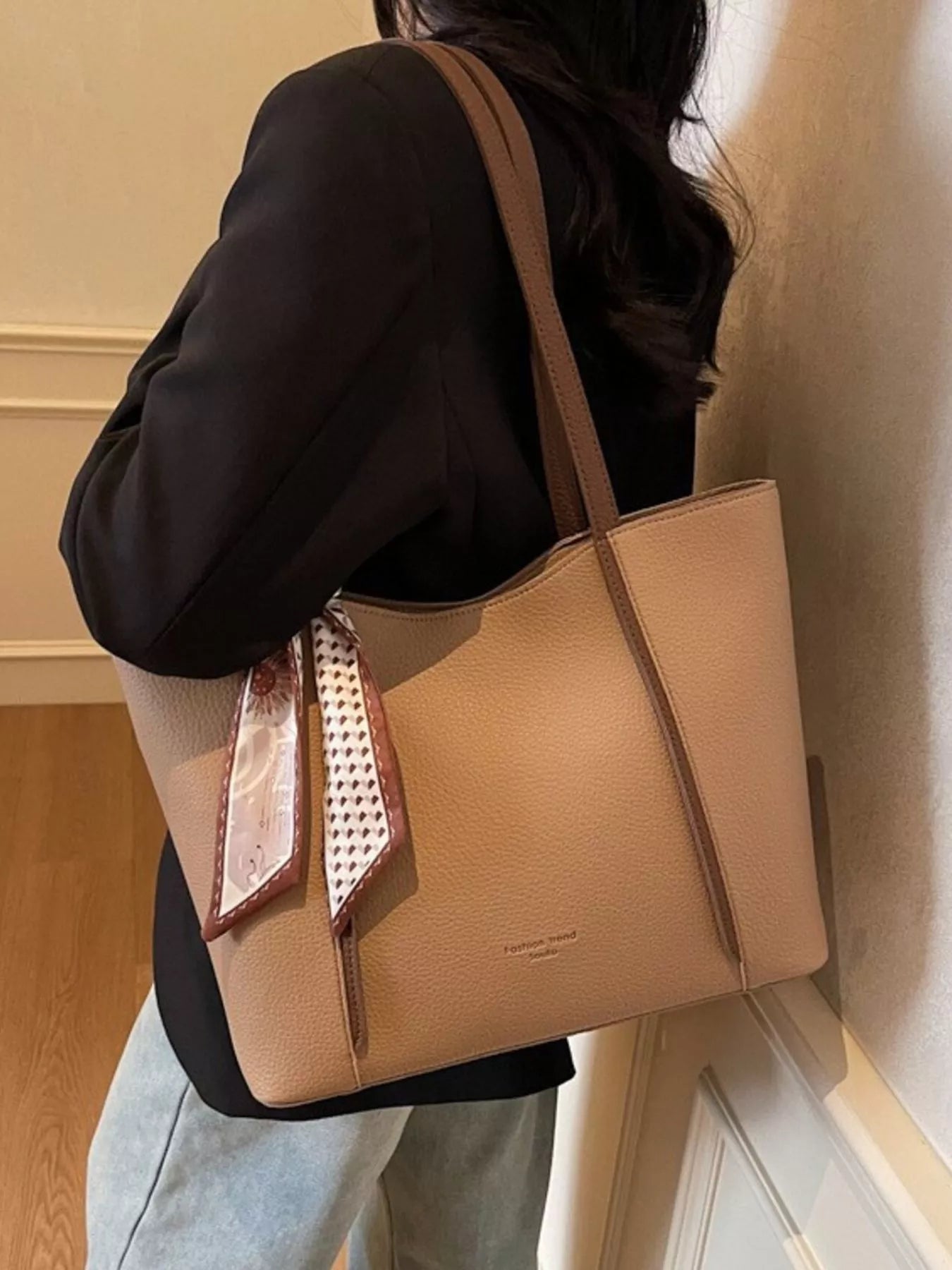 Khaki PU leather tote bag hanging at shoulder, open top and scarf accent