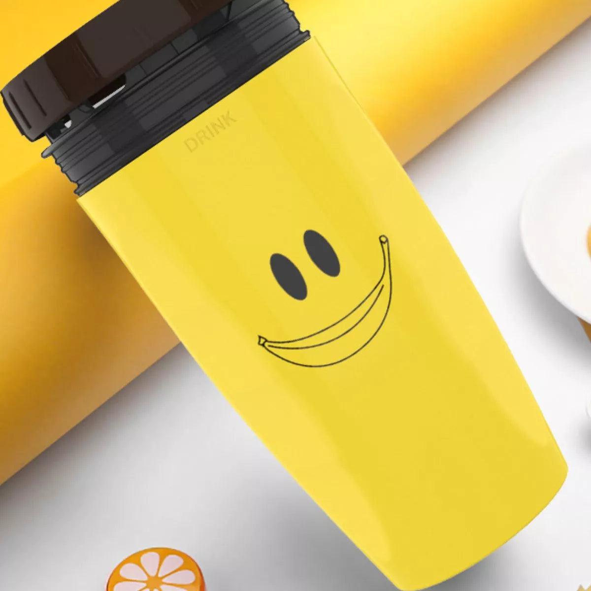 Yellow kettle close-up with smiley face decal and DRINK label