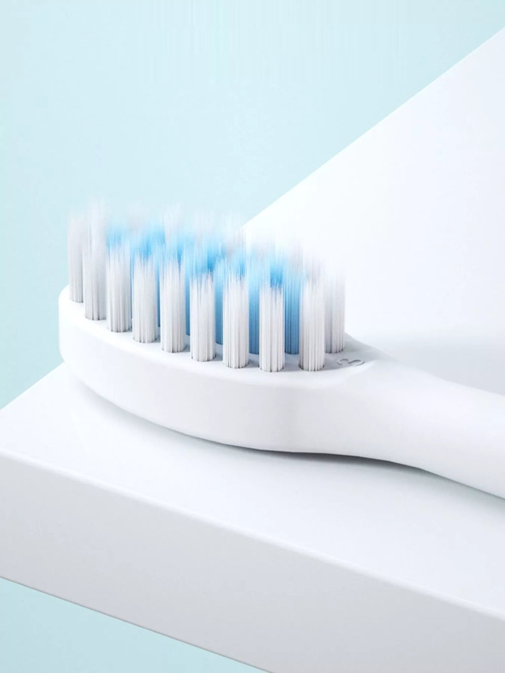 Close-up of electric toothbrush bristles in blue on the white head