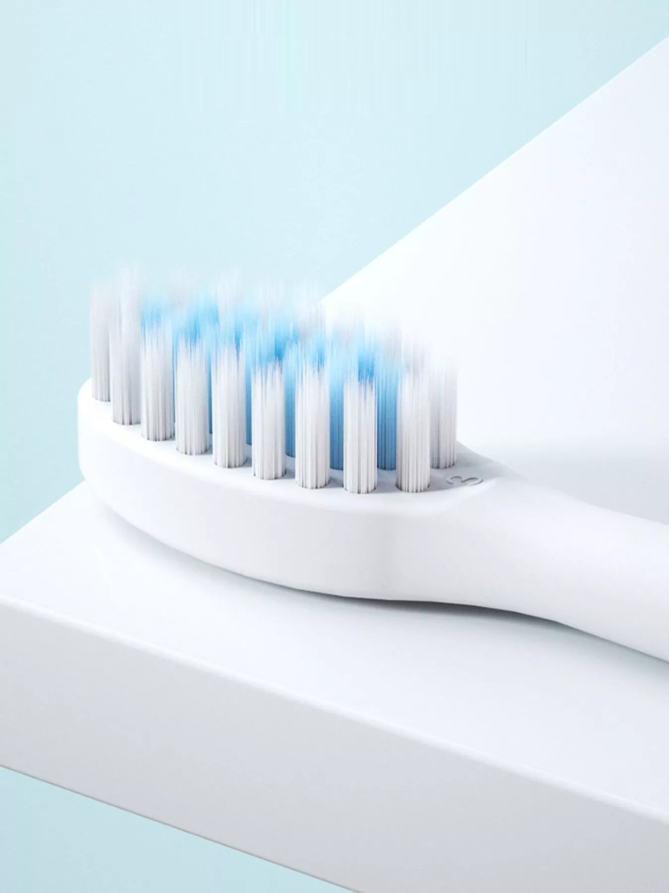 Close-up of electric toothbrush bristles in blue on the white head