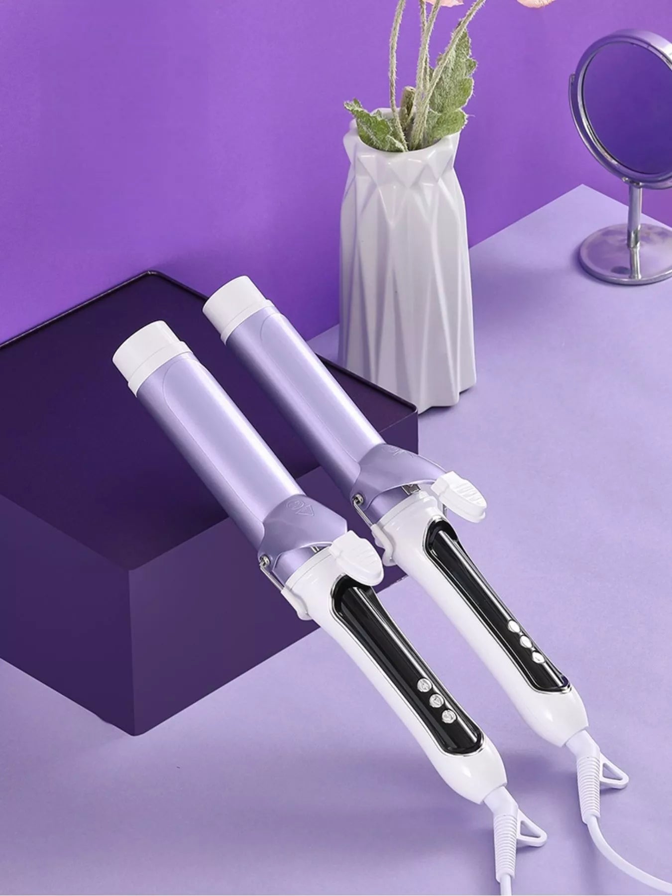 Two purple automatic rotating ceramic curling irons with white stands and cords.
