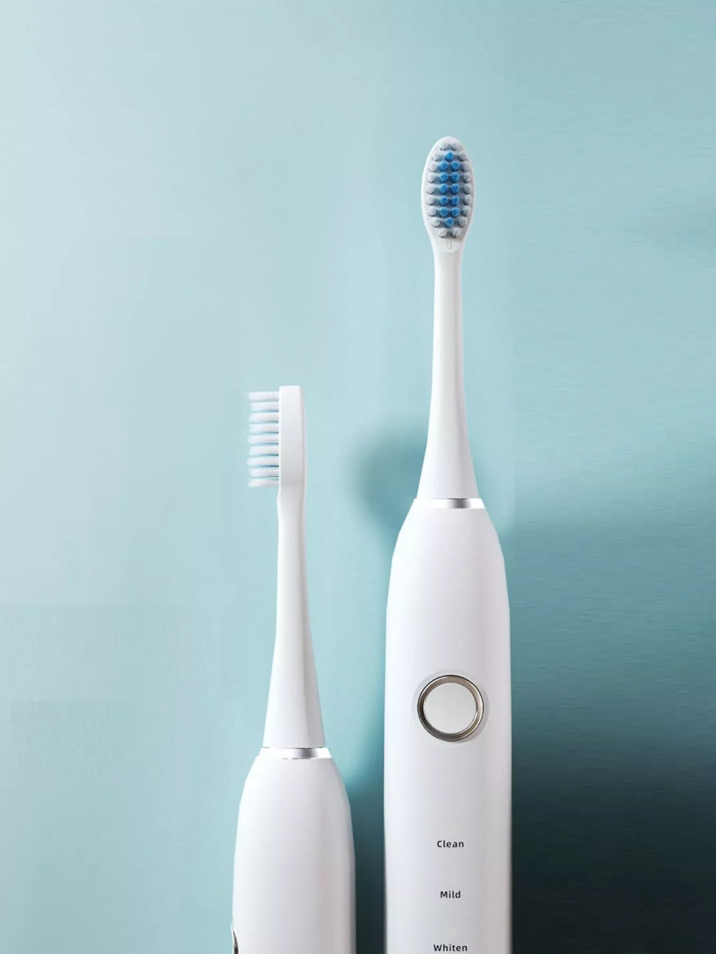 White electric toothbrush head and handle with circular mode button