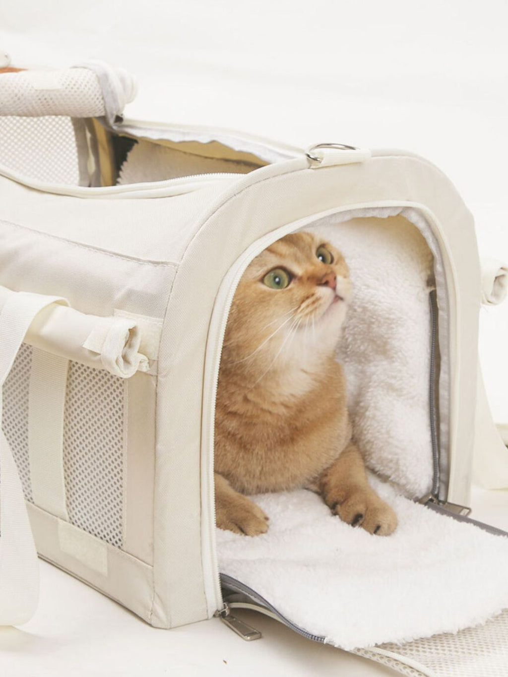 Comfortable pet carrier bag with liner, side zip entry and mesh panels, white.