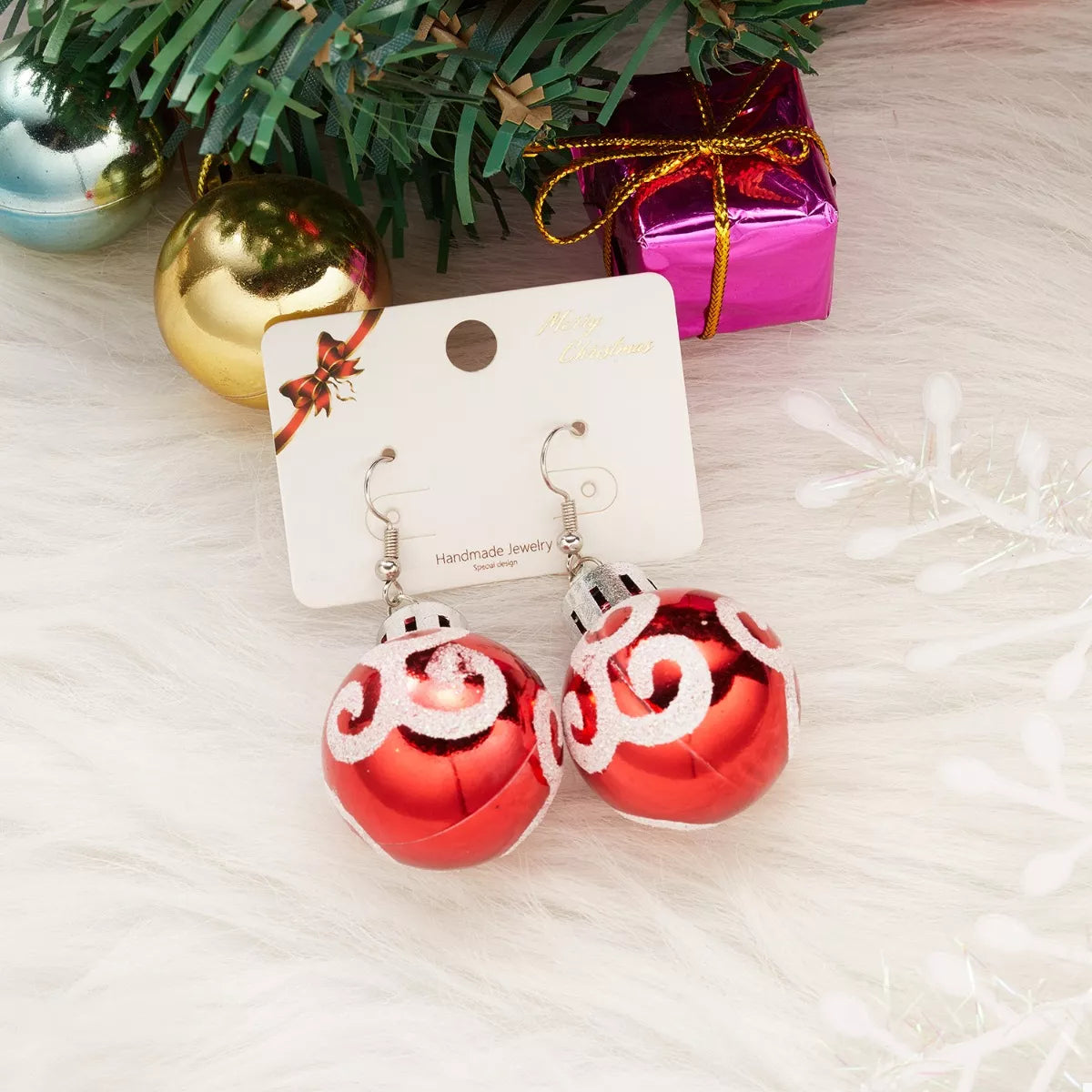 Red holiday ball drop earrings with swirl pattern, silver-tone top and dangle hooks