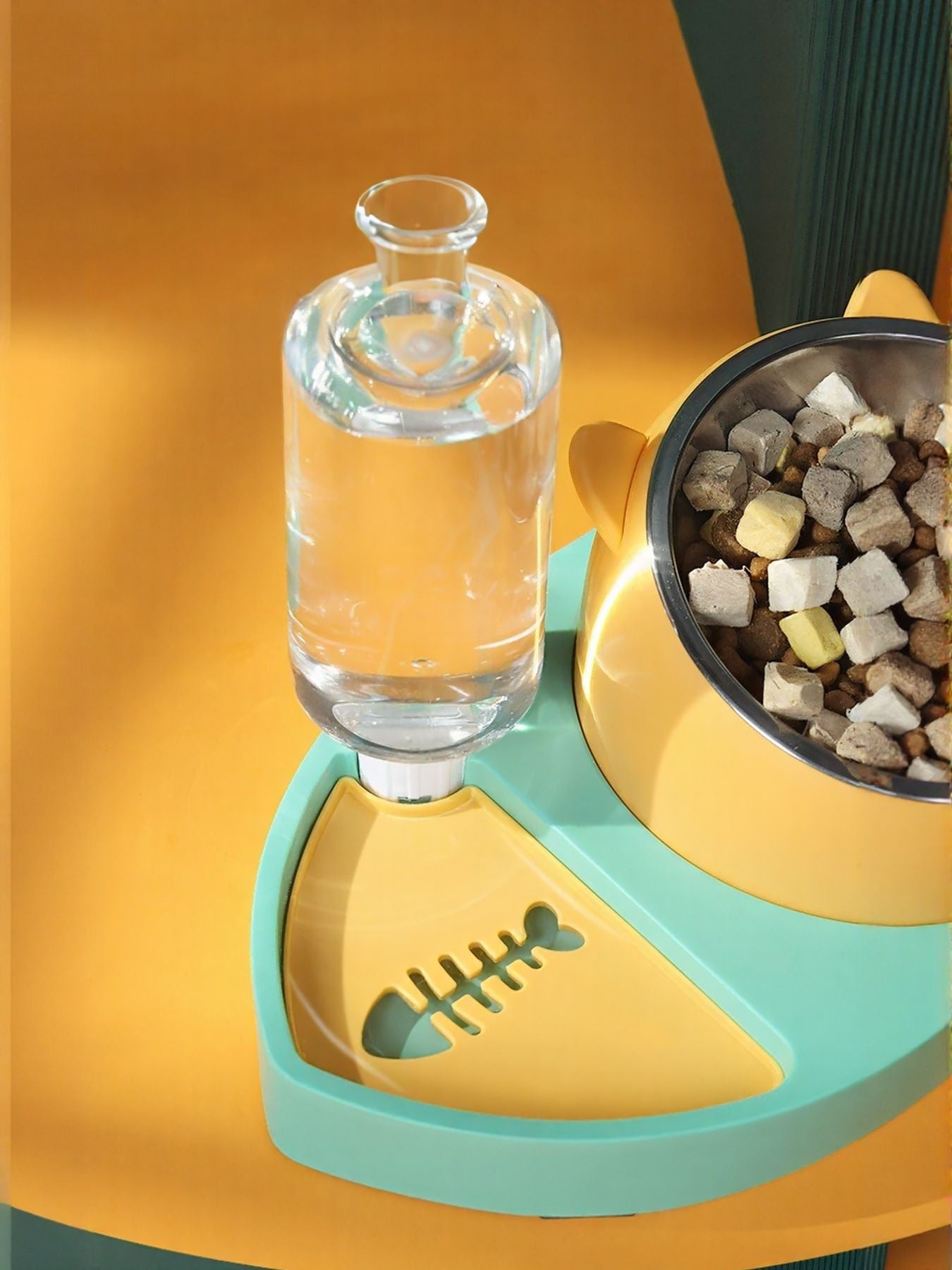 Teal and yellow automatic water refill pet bowl with glass water bottle and side food dish