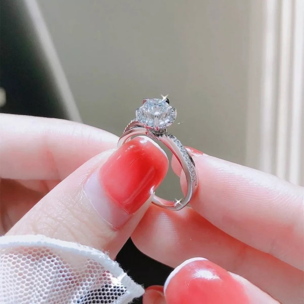 Sterling silver moissanite ring close-up, round center stone with pavé band