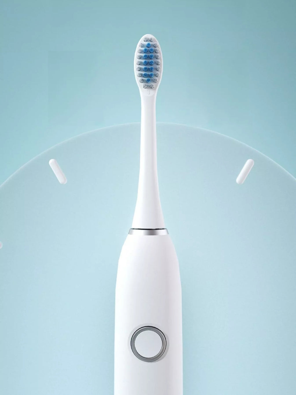 White electric toothbrush close-up with round mode control on handle