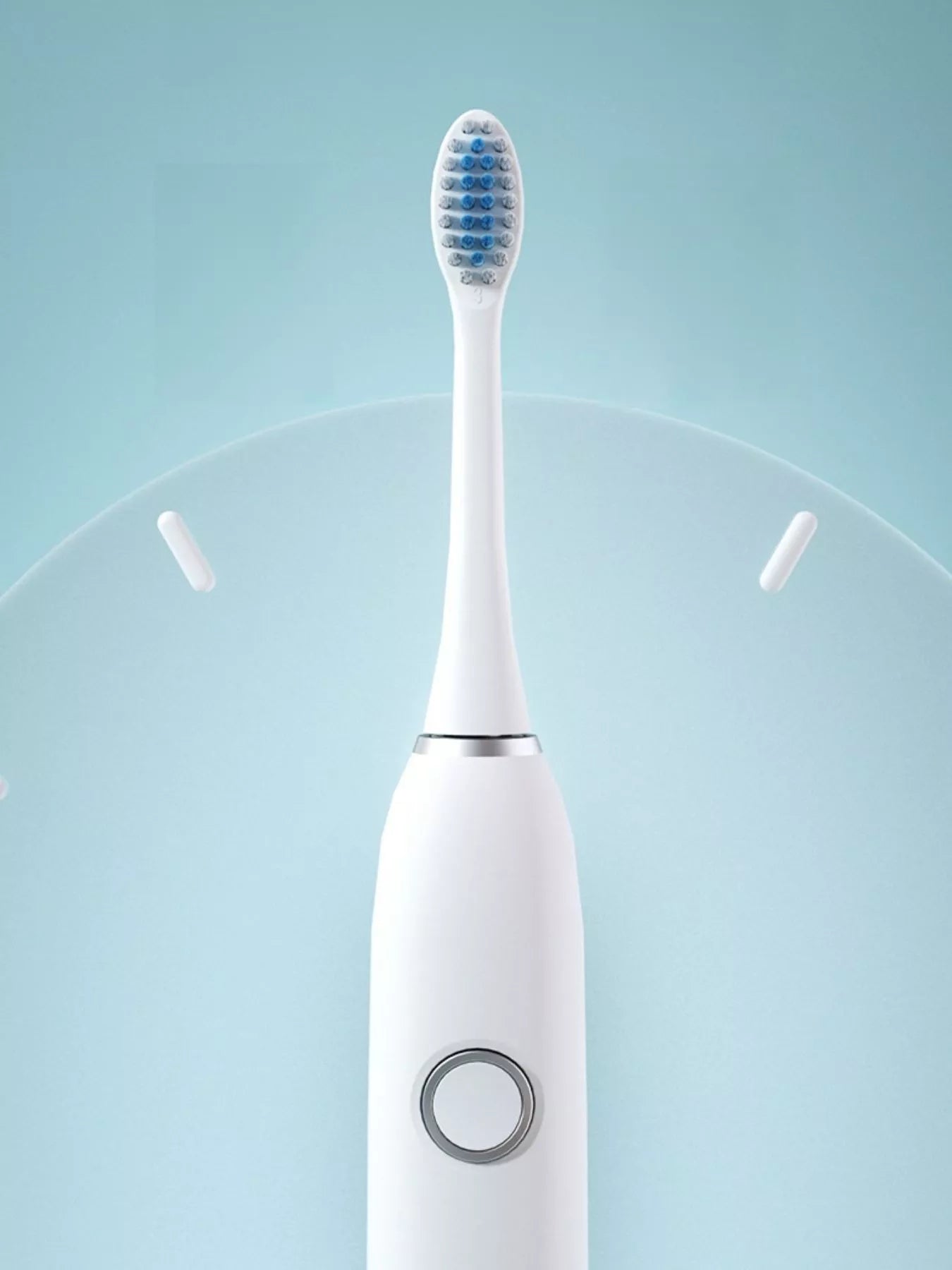 White electric toothbrush close-up with round mode control on handle
