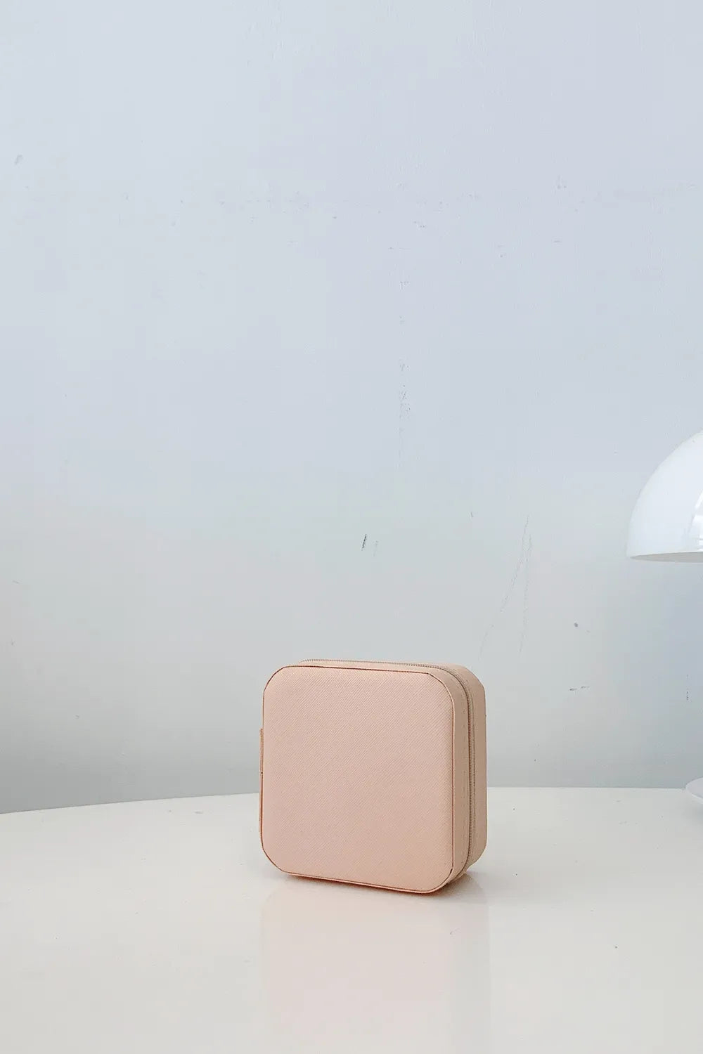 Blush pink PU leather square jewelry box with stitched edges, closed