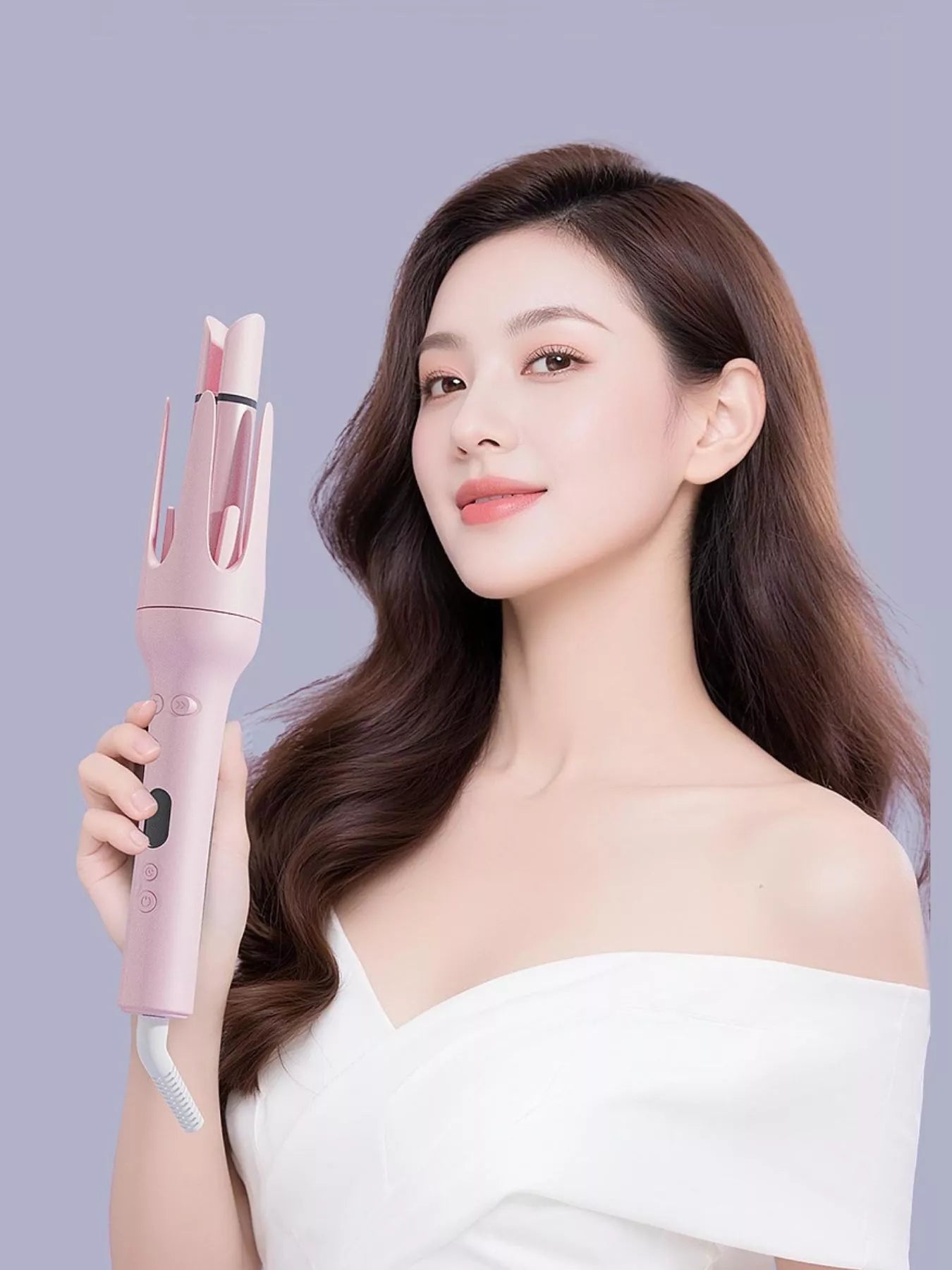 Woman holding Dusty Pink automatic rotating ceramic hair curler in hand