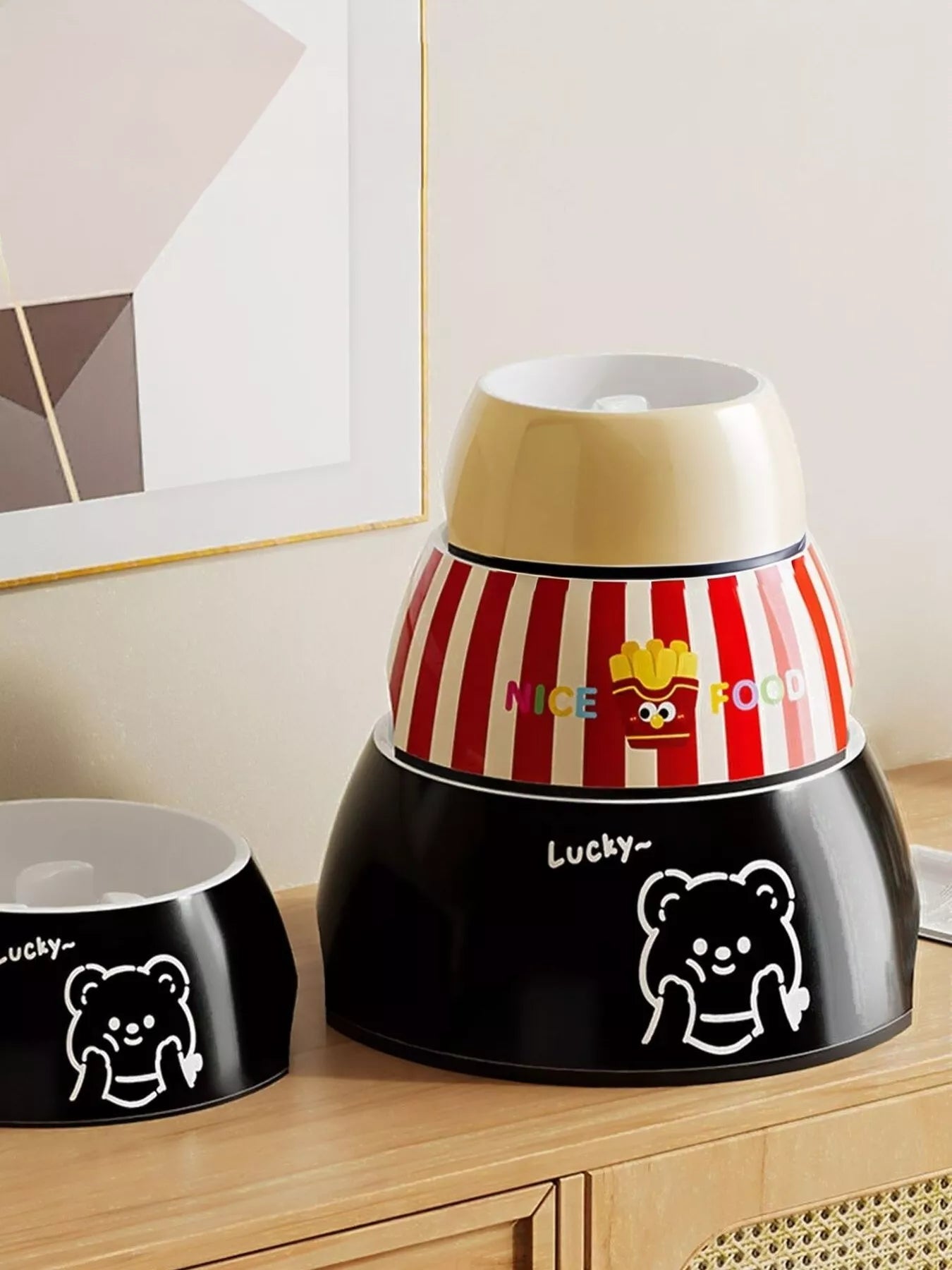 Red striped pet bowl with cartoon character icons and Lucky bear front