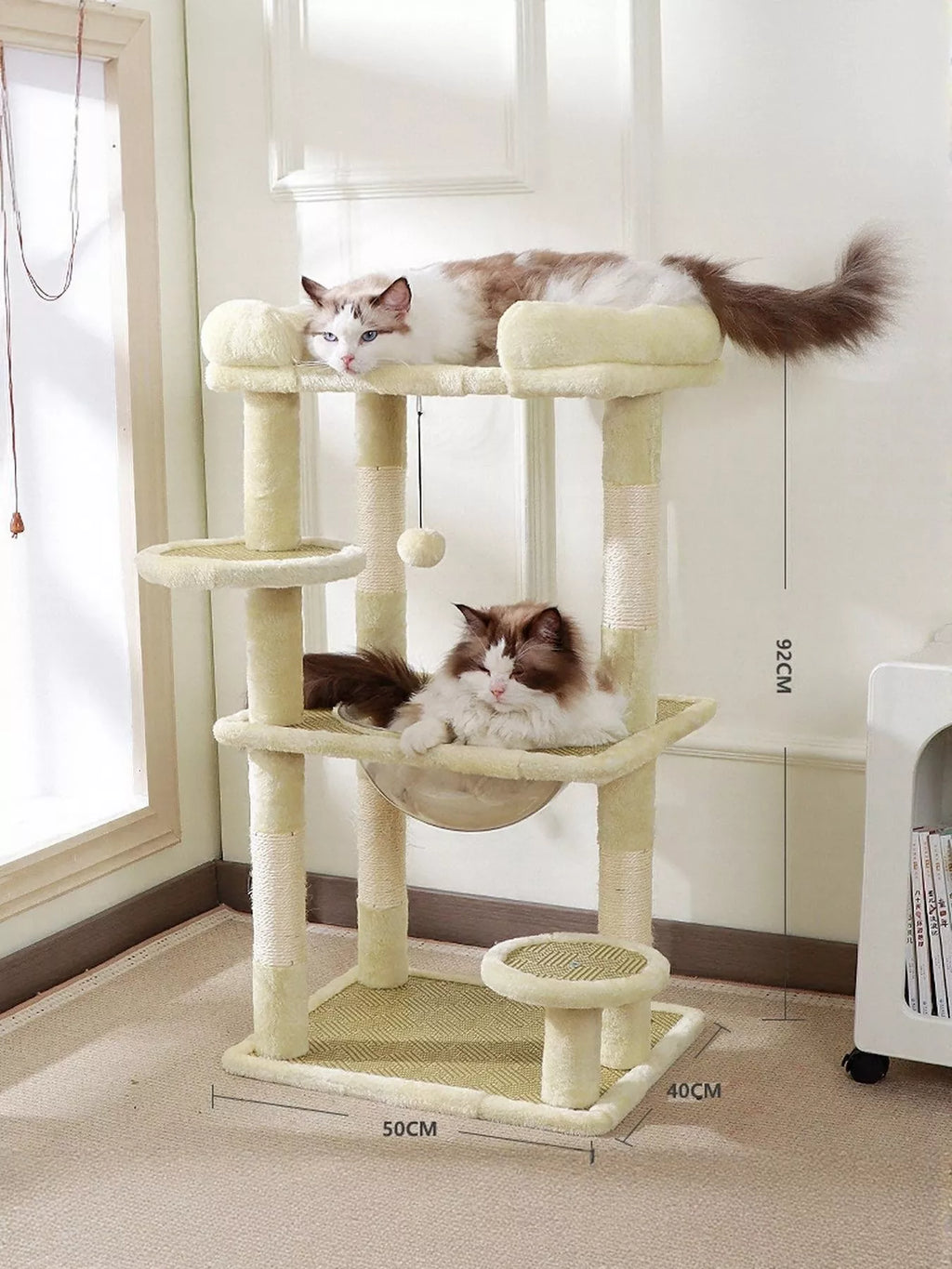 Plush cat tree condo with cream platforms and two scratching posts; soft top perch
