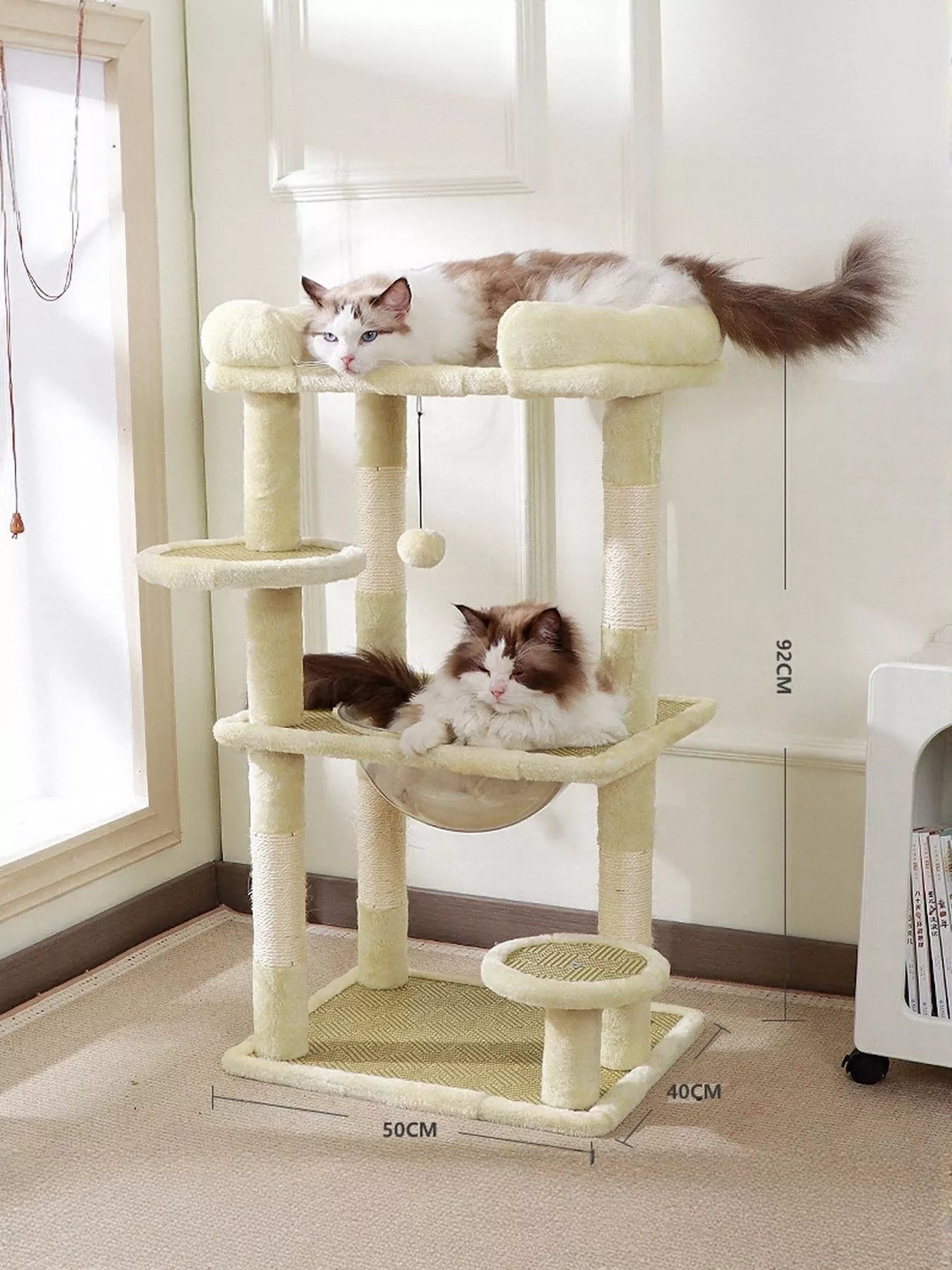Plush cat tree condo with cream platforms and two scratching posts; soft top perch