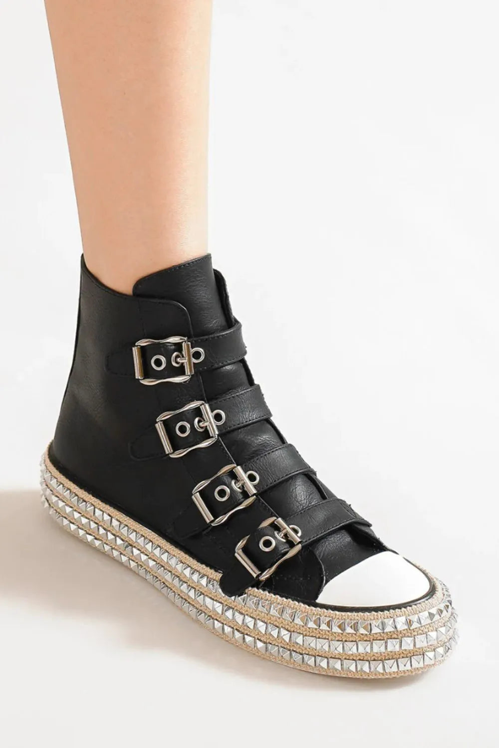 Black platform sneaker with 4-buckle strap detail and textured studded edge