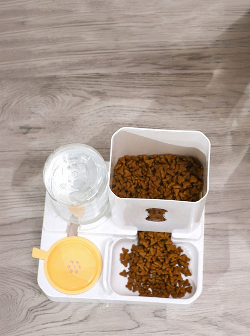 Automatic pet food and water dispenser showing filled food bins and water reservoir.