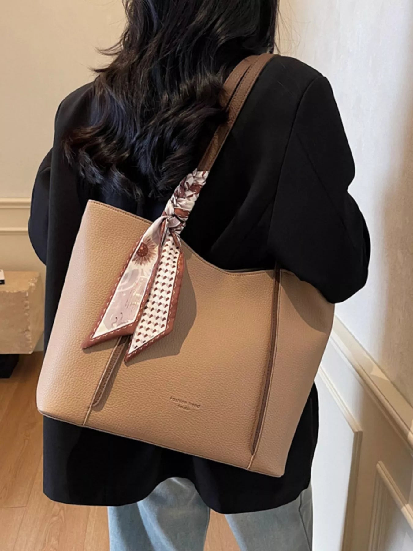 Back view of khaki PU leather tote bag with scarf tie on the handles