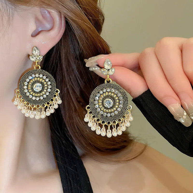 White rhinestone beaded dangle earrings with pearl fringe and gold-tone setting