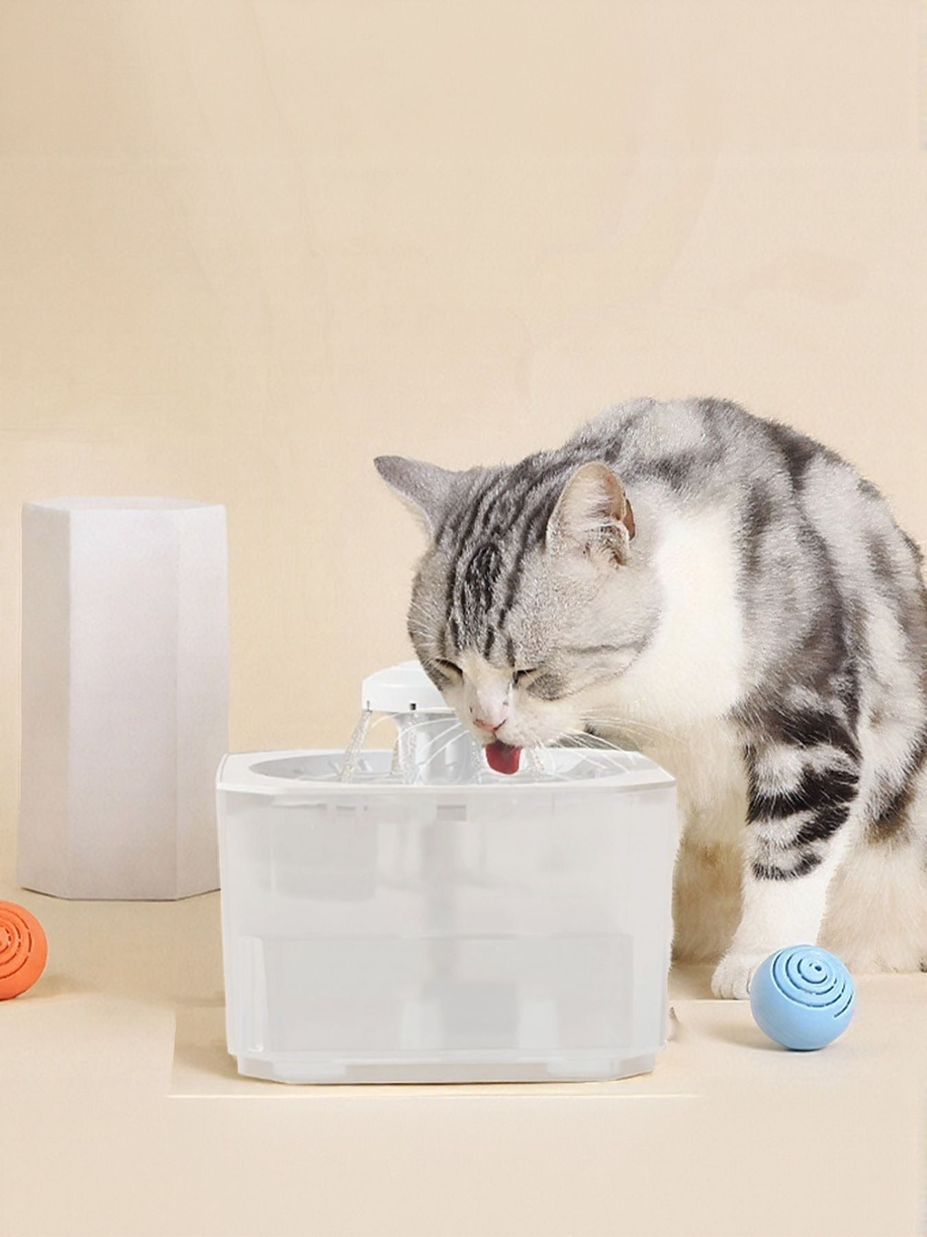 Pet water fountain with white nozzle, clear top and splashing recirculating water