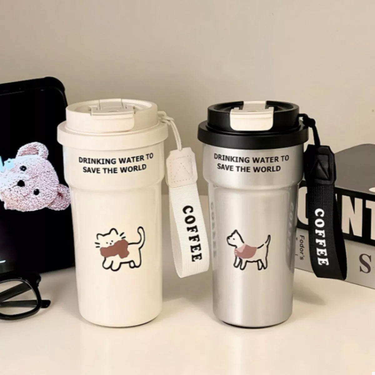 Two cat tumblers with straws, cream and black lids, 'DRINKING WATER' text