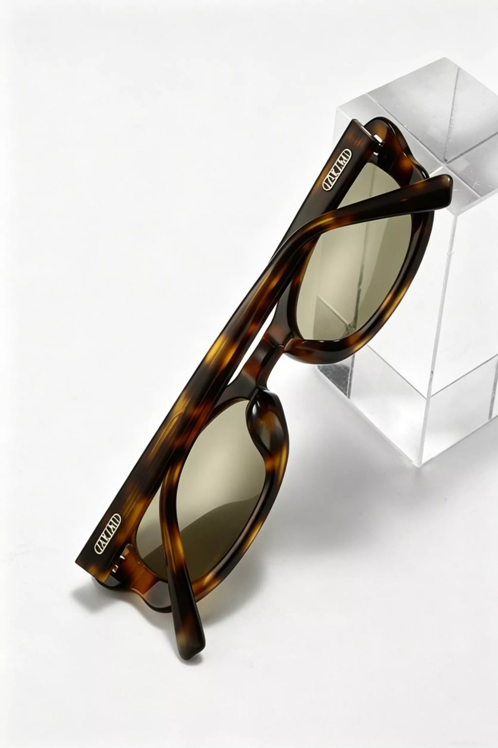 Brown tortoiseshell sunglasses, side view with curved temples and oval lenses