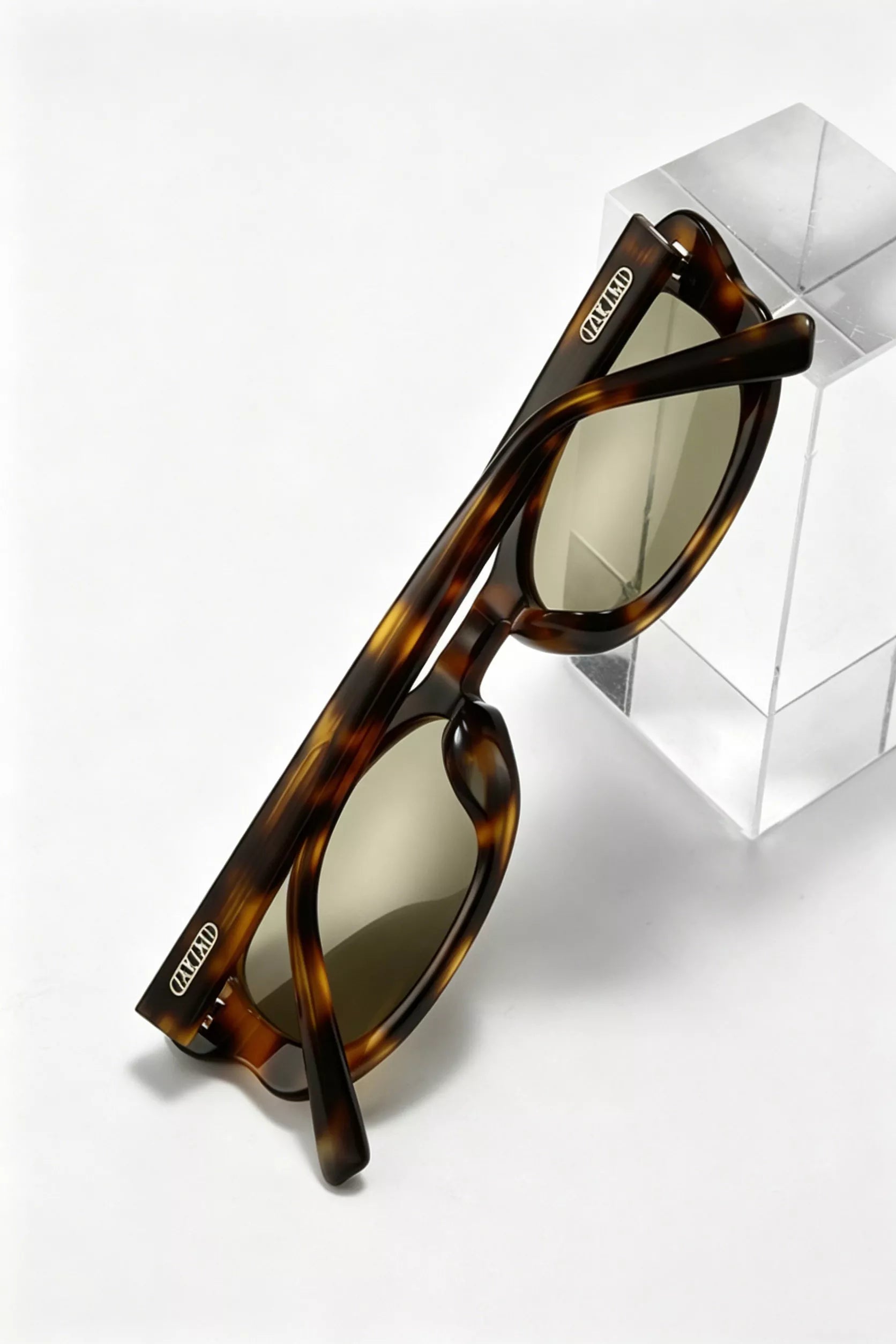 Brown tortoiseshell sunglasses, side view with curved temples and oval lenses