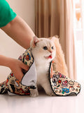 Cartoon pet bath towel with paw trim, wrapped around a small cat for drying